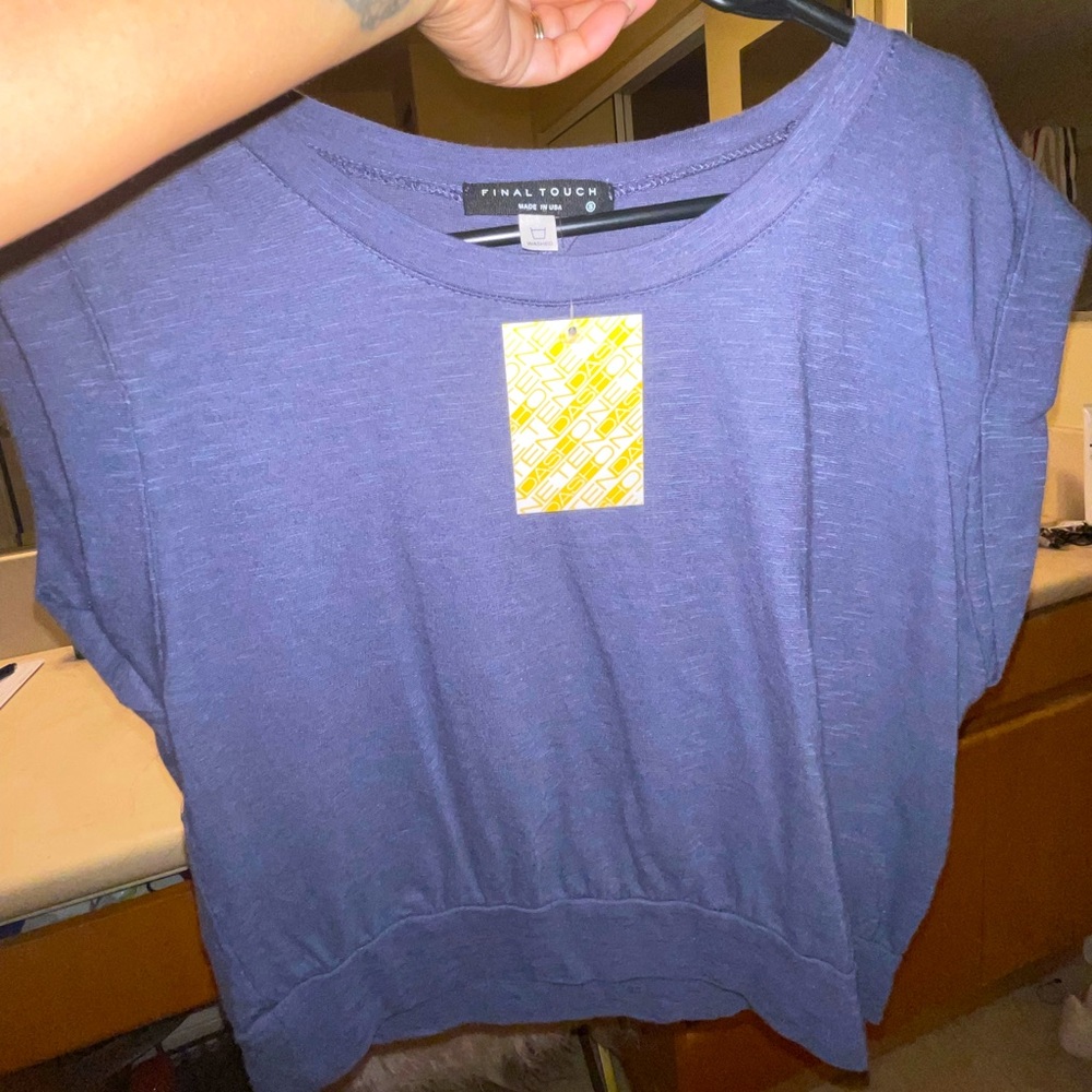 Small blue somewhat of a crop top but not really open back , super cute